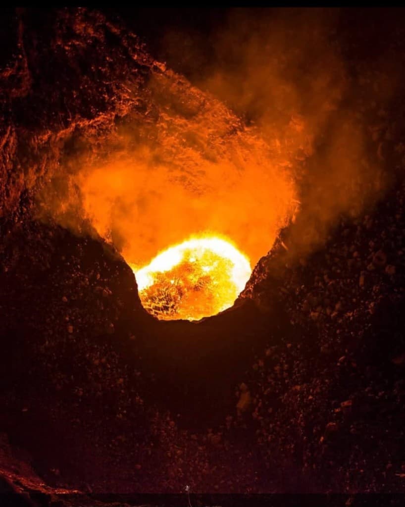 Looking into an active volcanic crater with glowing lava