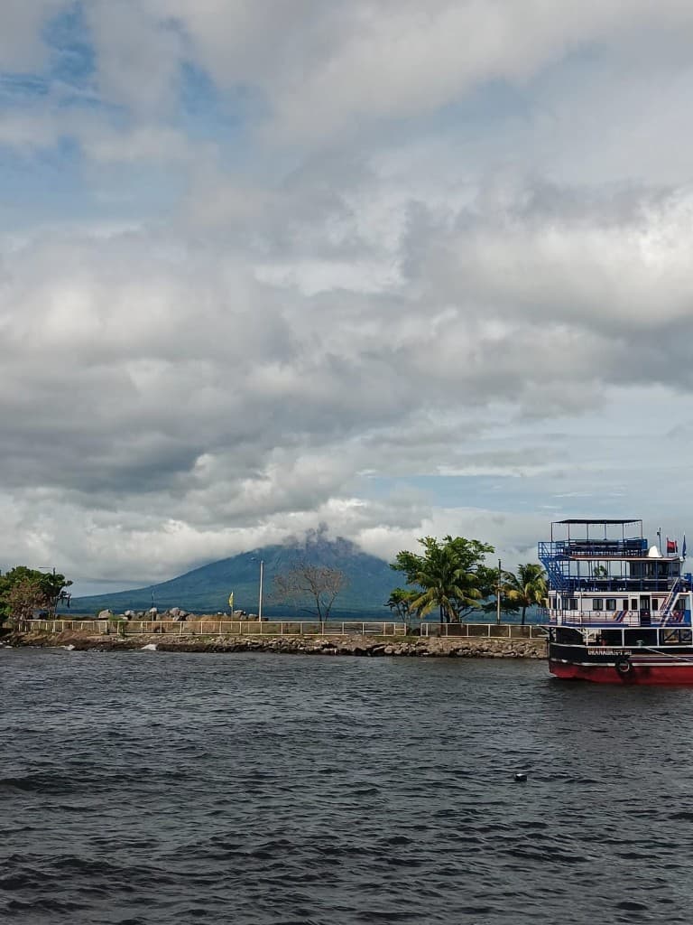Lake and volcano view with ferry on the water