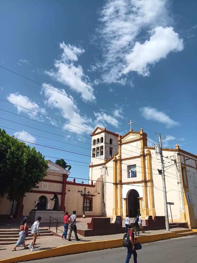 Colonial church with white facade under a bright sky
