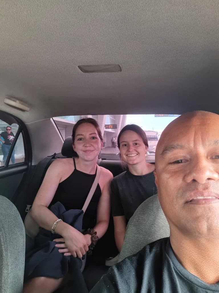 Smiling passengers in the back seat after a ride