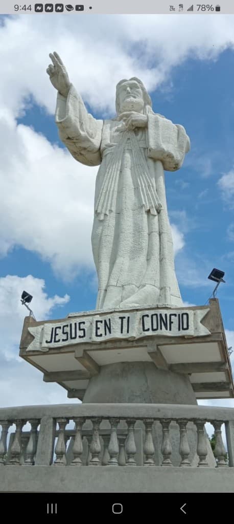 White statue of Christ against a blue sky