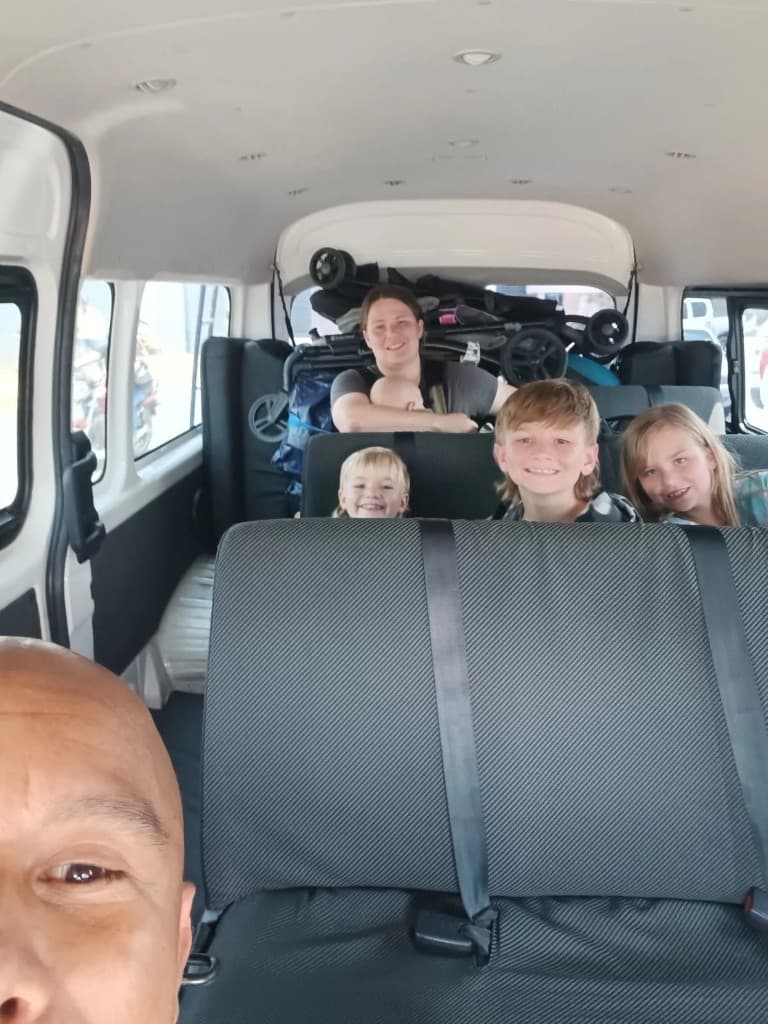 Family smiling inside a spacious passenger van